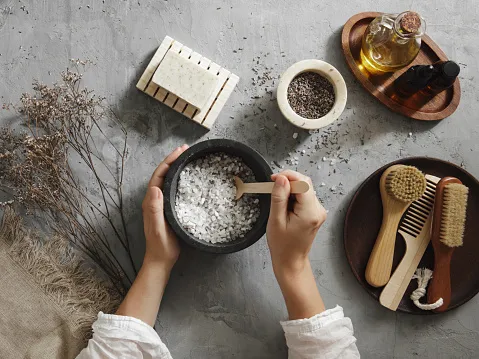 Woman making homemade bath salt with lavender Woman making homemade bath salt with lavender