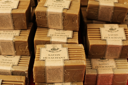 "Saillans, France - August 5, 2012: Stacks of traditional Savon de Marseille soap on display at an open-air market."