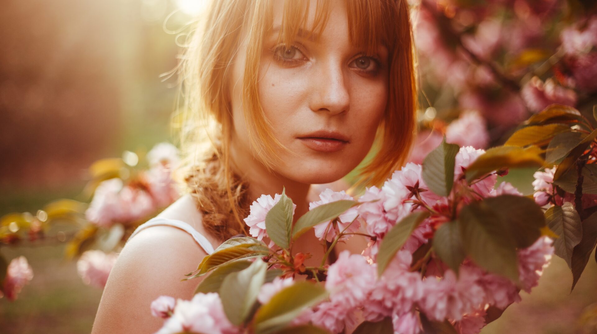 A,Red-haired,Girl,With,Fringe,Looks,Curiously,While,Standing,Between